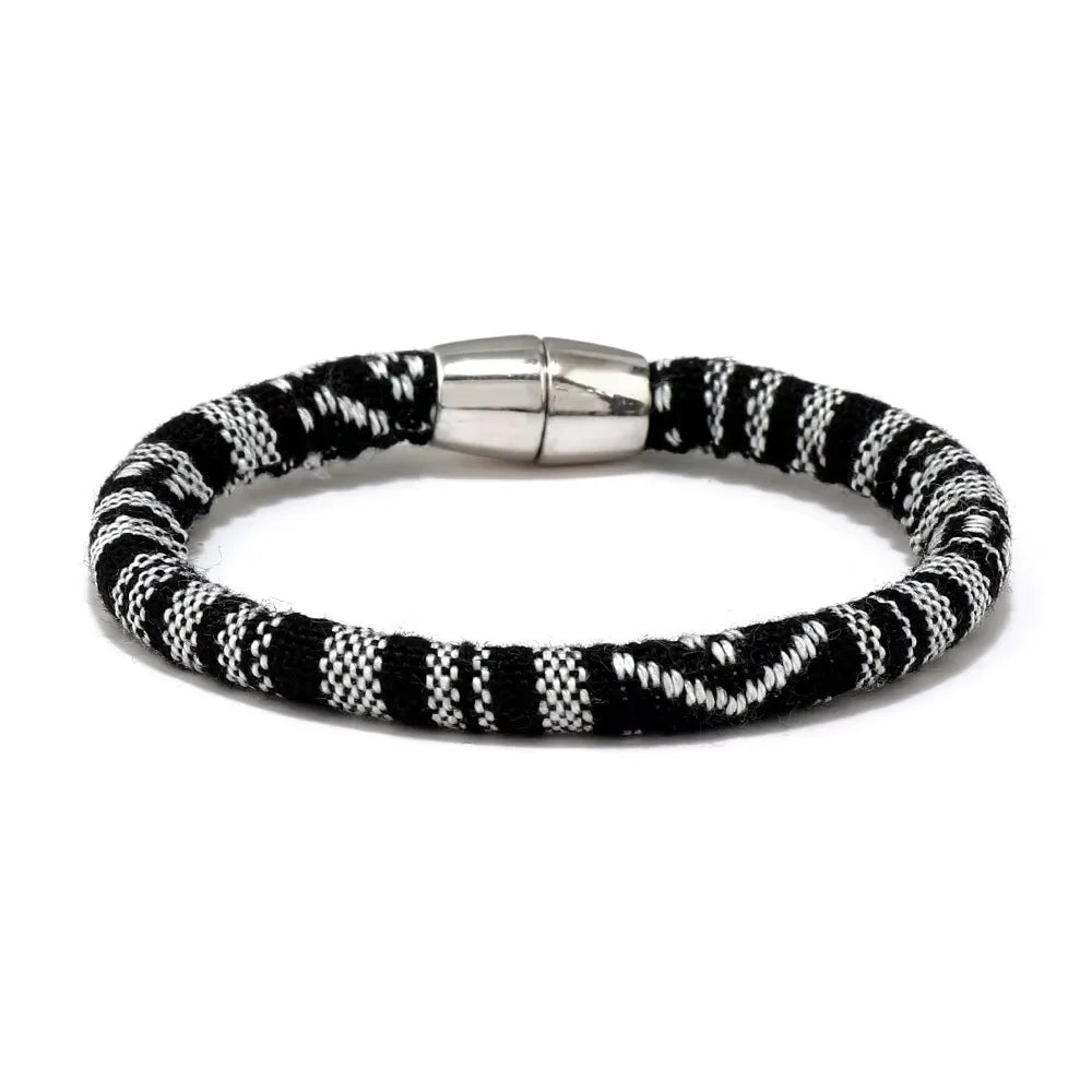 Midnight Stripes Bracelet featuring a smooth roll-over design in black and white, handcrafted in Nepal.
